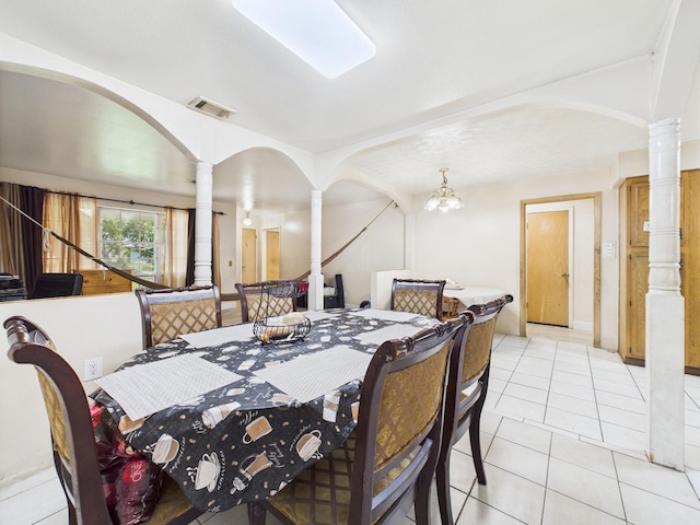 8206 Dillon St, Houston, TX 77061 - dining area with ornate columns, light tile patterned floors, and arched walkways