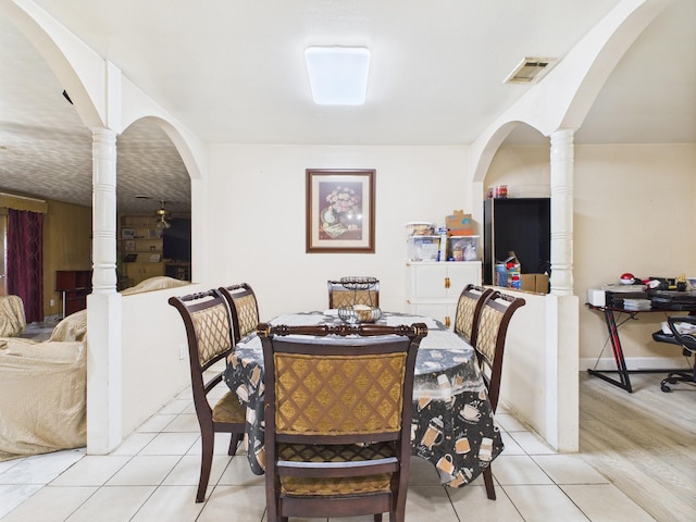 8206 Dillon St, Houston, TX 77061 - dining room featuring light tile patterned floors, arched walkways, and decorative columns