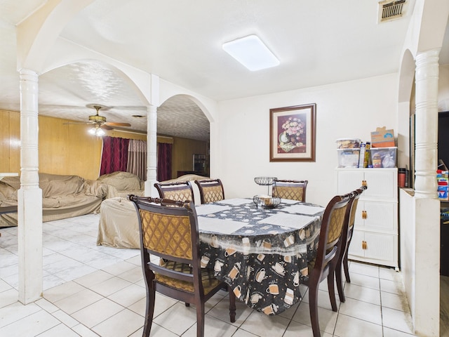 8206 Dillon St, Houston, TX 77061 - dining space with decorative columns, ceiling fan, light tile patterned floors, and arched walkways