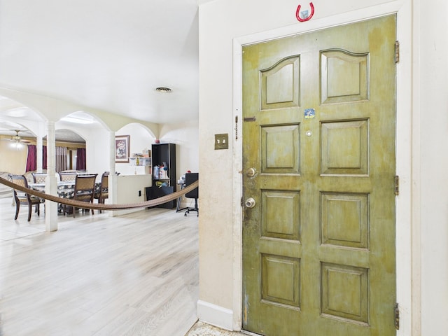8206 Dillon St, Houston, TX 77061 - entrance foyer with decorative columns, arched walkways, baseboards, and wood finished floors