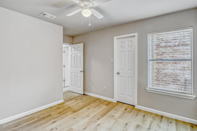 19822 Laurel Trail Dr, Cypress, TX 77433 - unfurnished bedroom featuring multiple windows, baseboards, wood finished floors, and a ceiling fan