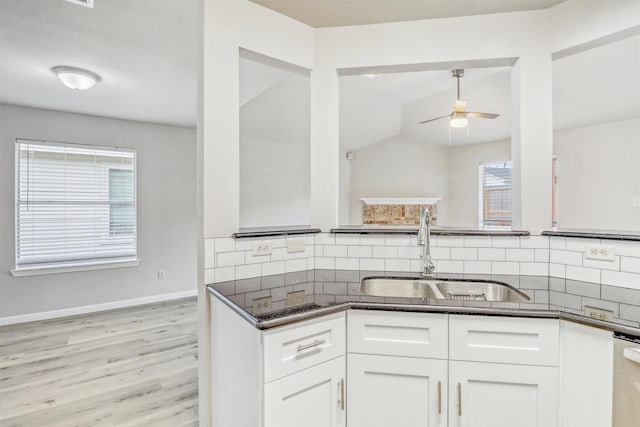 19822 Laurel Trail Dr, Cypress, TX 77433 - kitchen with a sink, decorative backsplash, white cabinetry, ceiling fan, and light wood finished floors