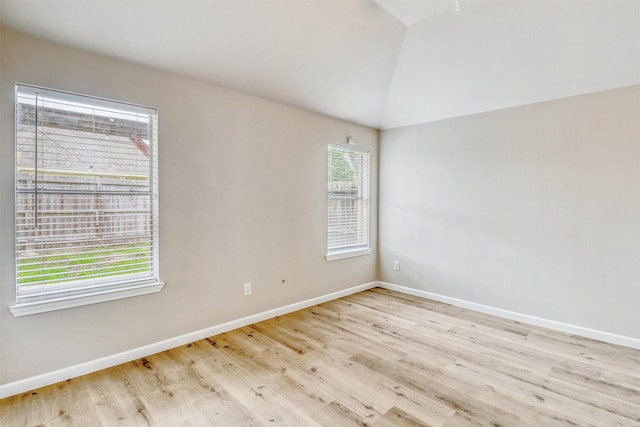 19822 Laurel Trail Dr, Cypress, TX 77433 - empty room with light wood-style flooring, vaulted ceiling, and baseboards