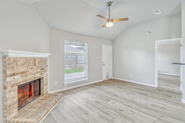 19822 Laurel Trail Dr, Cypress, TX 77433 - unfurnished living room with lofted ceiling, light wood-style floors, a ceiling fan, a brick fireplace, and baseboards