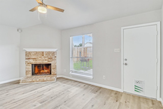 19822 Laurel Trail Dr, Cypress, TX 77433 - unfurnished living room featuring vaulted ceiling, light wood-style floors, a ceiling fan, a fireplace, and baseboards