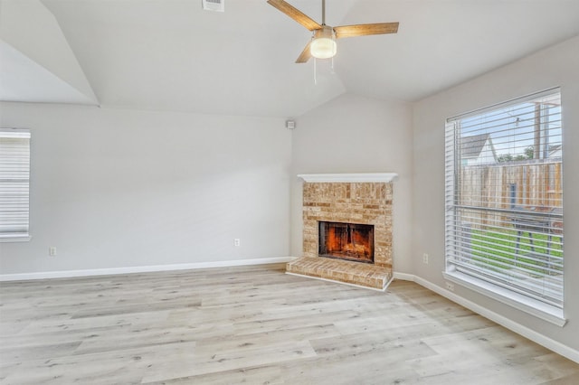 19822 Laurel Trail Dr, Cypress, TX 77433 - unfurnished living room with lofted ceiling, light wood-type flooring, a fireplace, baseboards, and ceiling fan