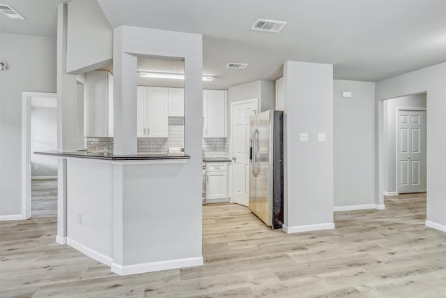 19822 Laurel Trail Dr, Cypress, TX 77433 - kitchen with stainless steel fridge with ice dispenser, white cabinetry, light wood-type flooring, and decorative backsplash
