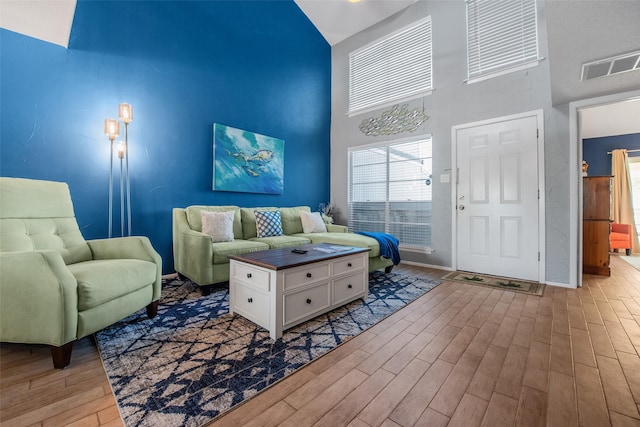 103 Jean Lafitte Cv, Galveston, TX 77554 - living room with a high ceiling, wood finished floors, and baseboards