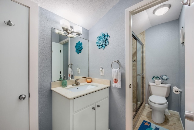 103 Jean Lafitte Cv, Galveston, TX 77554 - bathroom featuring toilet, vanity, a shower stall, and a textured wall