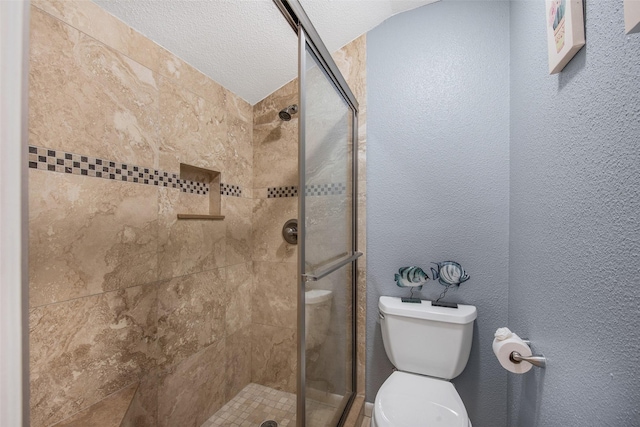 103 Jean Lafitte Cv, Galveston, TX 77554 - bathroom featuring toilet, a stall shower, and a textured ceiling
