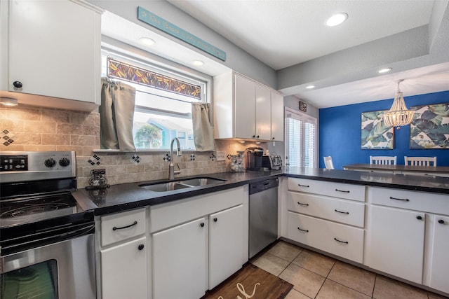 103 Jean Lafitte Cv, Galveston, TX 77554 - kitchen with stainless steel appliances, a sink, dark countertops, and recessed lighting