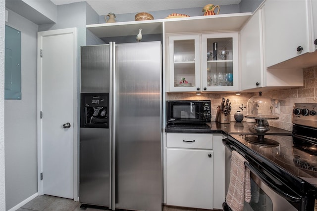 103 Jean Lafitte Cv, Galveston, TX 77554 - kitchen with appliances with stainless steel finishes, white cabinetry, dark countertops, tasteful backsplash, and glass insert cabinets