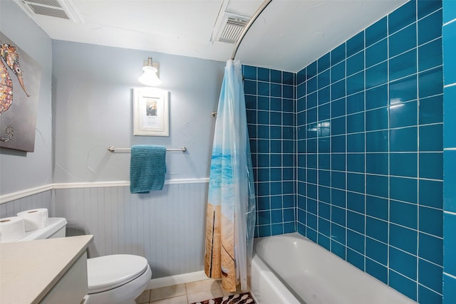 103 Jean Lafitte Cv, Galveston, TX 77554 - full bath featuring toilet, vanity, wainscoting, tile patterned floors, and shower / bath combination with curtain