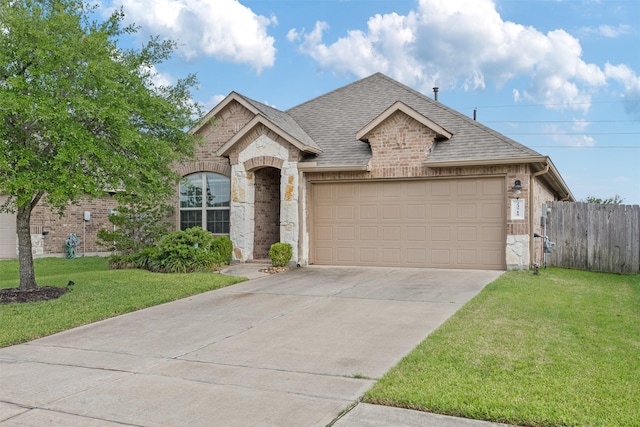 23715 Rivage Ridge Dr, Katy, TX 77493 - french country home featuring brick siding, roof with shingles, an attached garage, concrete driveway, and stone siding