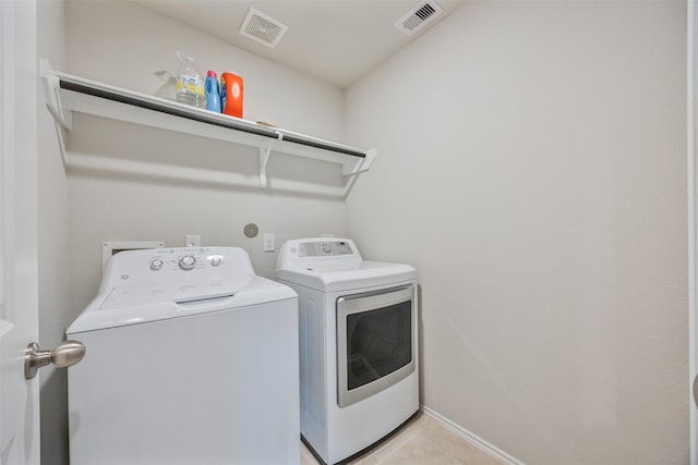 23715 Rivage Ridge Dr, Katy, TX 77493 - laundry area with washing machine and dryer, light tile patterned floors, and baseboards