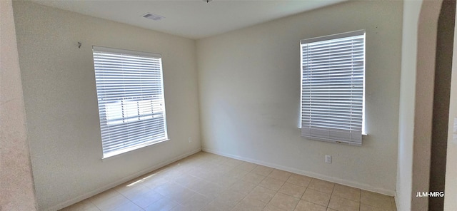 4903 Jagged Cliff Ln, Rosenberg, TX 77469 - spare room featuring healthy amount of natural light, light tile patterned flooring, and baseboards