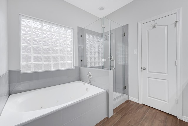 7818 Silver Lure Dr, Humble, TX 77346 - bathroom featuring a stall shower, a whirlpool tub, wood finished floors, and baseboards