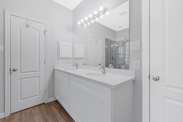 7818 Silver Lure Dr, Humble, TX 77346 - bathroom featuring double vanity, a shower stall, and wood finished floors