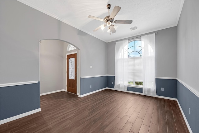 7818 Silver Lure Dr, Humble, TX 77346 - unfurnished room featuring dark wood-style floors, baseboards, a ceiling fan, crown molding, and arched walkways