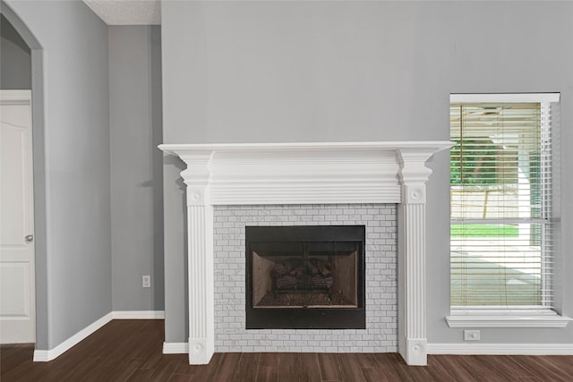 7818 Silver Lure Dr, Humble, TX 77346 - detailed view of wood finished floors, a fireplace, baseboards, and arched walkways