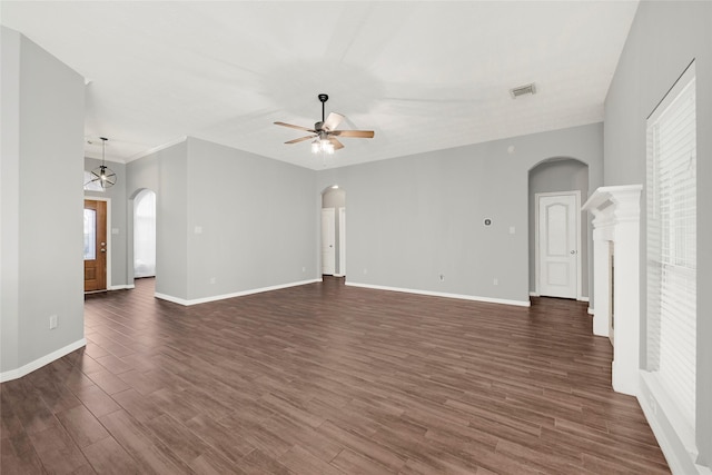 7818 Silver Lure Dr, Humble, TX 77346 - unfurnished living room with arched walkways, a ceiling fan, and dark wood finished floors