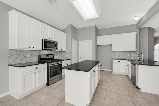 7818 Silver Lure Dr, Humble, TX 77346 - kitchen featuring stainless steel appliances, a sink, and dark countertops