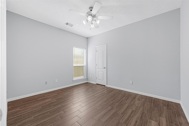 7818 Silver Lure Dr, Humble, TX 77346 - empty room with dark wood-style floors, baseboards, ceiling fan, and a textured ceiling