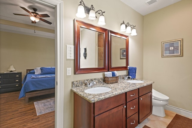 531 Private Road 6350, Dayton, TX 77535 - bathroom with double vanity, ensuite bathroom, a ceiling fan, and wood finished floors