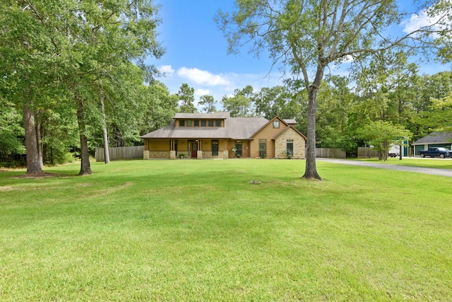 531 Private Road 6350, Dayton, TX 77535 - view of front of house with stone siding, asphalt driveway, and a porch