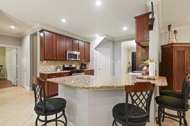 531 Private Road 6350, Dayton, TX 77535 - kitchen with appliances with stainless steel finishes, a kitchen bar, decorative backsplash, crown molding, and recessed lighting
