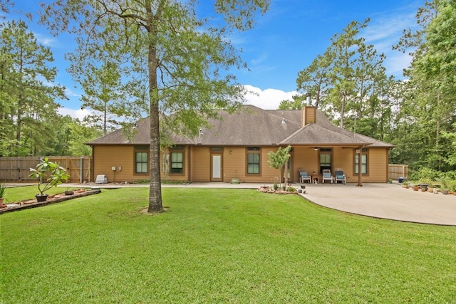 531 Private Road 6350, Dayton, TX 77535 - back of property with a chimney and a patio area