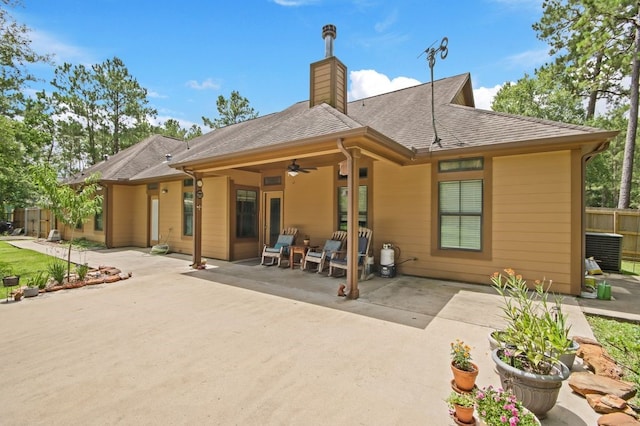 531 Private Road 6350, Dayton, TX 77535 - back of property with a patio, a ceiling fan, a chimney, and a shingled roof
