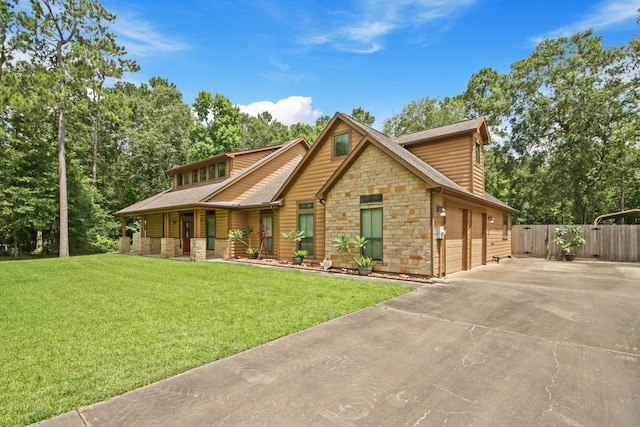 531 Private Road 6350, Dayton, TX 77535 - view of front of home with stone siding, driveway, and covered porch