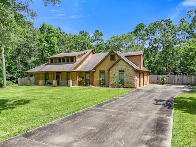 531 Private Road 6350, Dayton, TX 77535 - view of front of home featuring asphalt driveway, stone siding, a porch, a shingled roof, and a garage