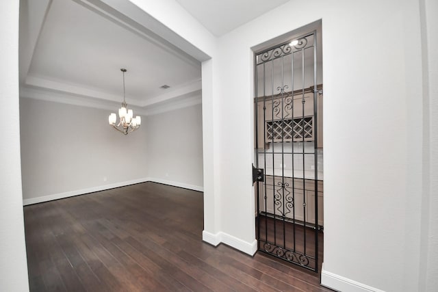 12813 N Palomino Lake Cir, Cypress, TX 77429 - foyer entrance with a tray ceiling, dark wood-style floors, baseboards, a chandelier, and crown molding