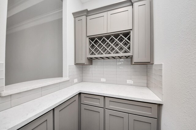 12813 N Palomino Lake Cir, Cypress, TX 77429 - kitchen with gray cabinets, backsplash, and light stone counters