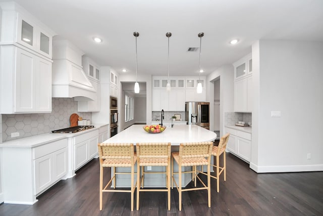 12813 N Palomino Lake Cir, Cypress, TX 77429 - kitchen with stainless steel appliances, dark wood-style flooring, tasteful backsplash, recessed lighting, and a center island with sink