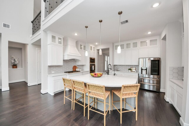 12813 N Palomino Lake Cir, Cypress, TX 77429 - kitchen featuring appliances with stainless steel finishes, premium range hood, light countertops, backsplash, and recessed lighting