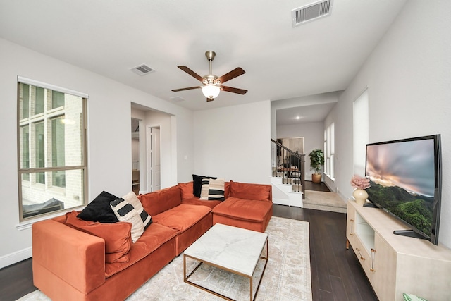 12813 N Palomino Lake Cir, Cypress, TX 77429 - living room featuring healthy amount of natural light, dark wood-style floors, stairway, and a ceiling fan