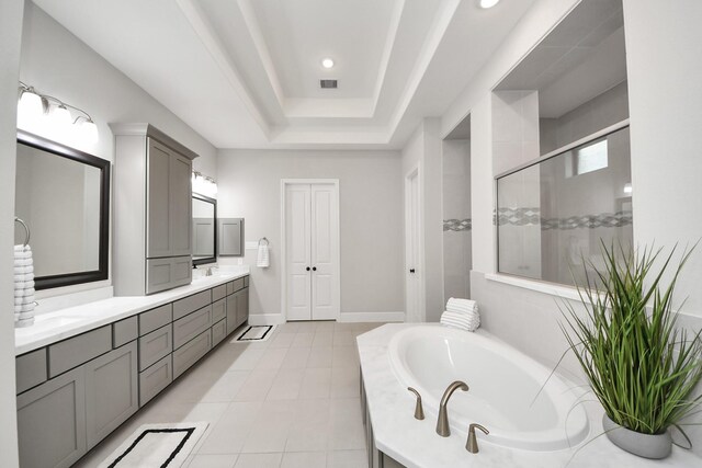 12813 N Palomino Lake Cir, Cypress, TX 77429 - bathroom with double vanity, a bath, a shower stall, a tray ceiling, and tile patterned flooring