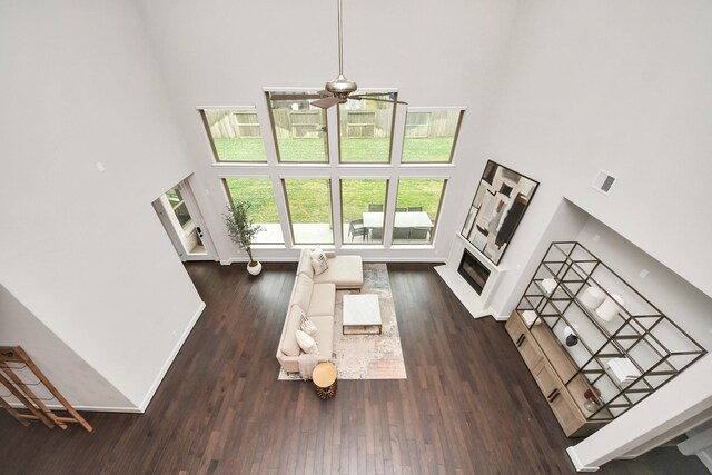 12813 N Palomino Lake Cir, Cypress, TX 77429 - living room with a high ceiling, a ceiling fan, wood finished floors, and a fireplace