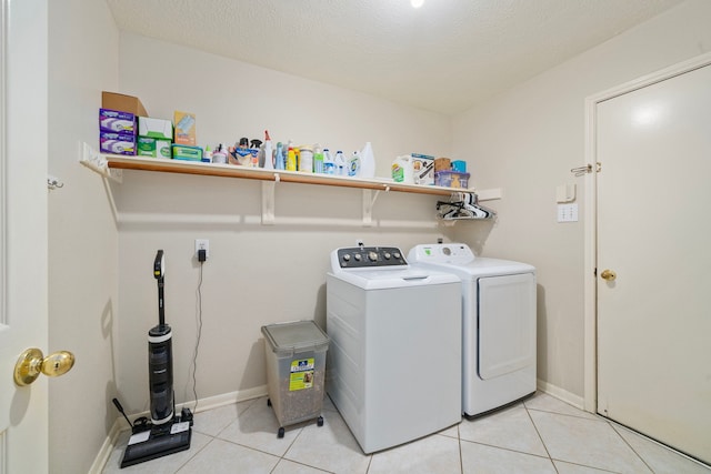9715 Therrell Dr, Houston, TX 77064 - washroom featuring washer and dryer, light tile patterned floors, and baseboards