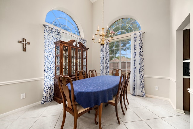 9715 Therrell Dr, Houston, TX 77064 - dining space featuring a chandelier, a towering ceiling, light tile patterned floors, and baseboards