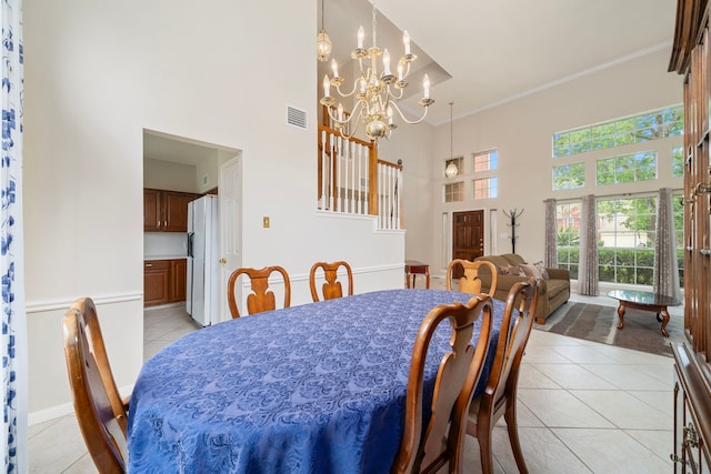9715 Therrell Dr, Houston, TX 77064 - dining area featuring a high ceiling, light tile patterned flooring, a chandelier, ornamental molding, and stairway