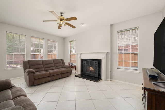 9715 Therrell Dr, Houston, TX 77064 - living room with a tiled fireplace, ceiling fan, light tile patterned flooring, and baseboards