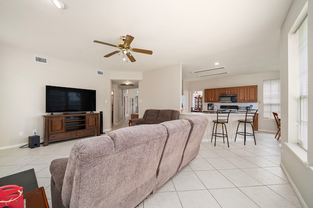 9715 Therrell Dr, Houston, TX 77064 - living area with light tile patterned floors, plenty of natural light, ceiling fan, baseboards, and recessed lighting