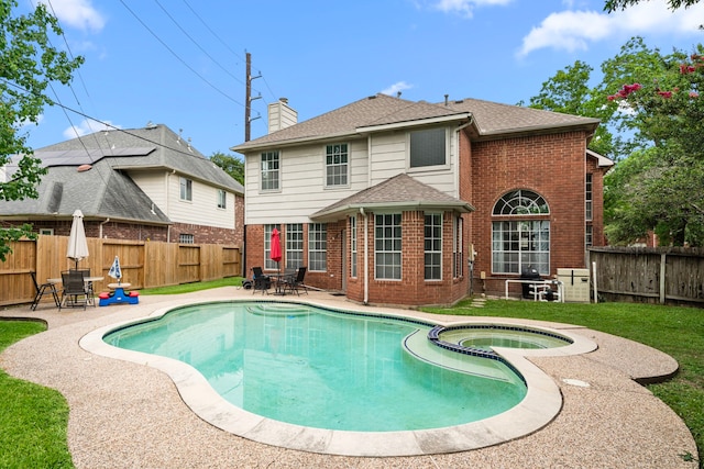 9715 Therrell Dr, Houston, TX 77064 - view of swimming pool with a patio, a pool with connected hot tub, and outdoor dining space