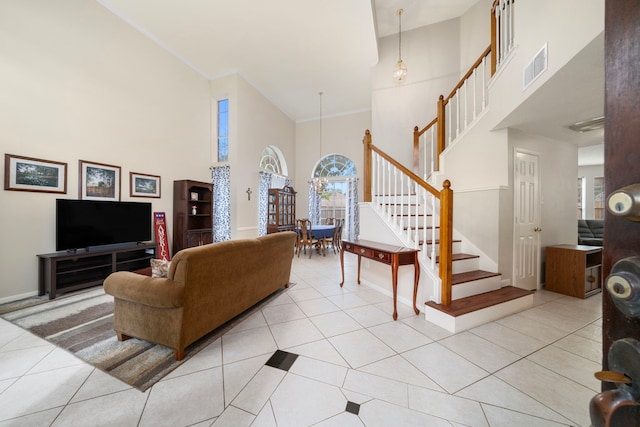 9715 Therrell Dr, Houston, TX 77064 - living area featuring a towering ceiling, stairs, light tile patterned floors, ornamental molding, and baseboards