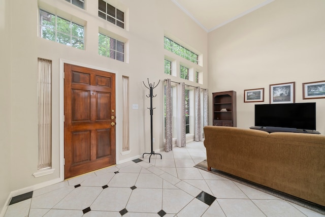 9715 Therrell Dr, Houston, TX 77064 - entryway with crown molding, light tile patterned floors, baseboards, a high ceiling, and plenty of natural light