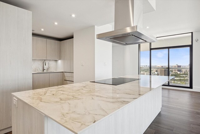 1701 Hermann Dr Unit 27Ce, Houston, TX 77004 - kitchen featuring island range hood, modern cabinets, a sink, black electric cooktop, and dark wood finished floors